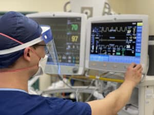 Anaesthetist checking monitor